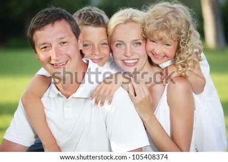 Family in summer park. Mother, father and children outdoors