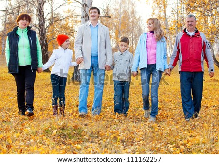 Families with children and grandparents in autumn park. Big family