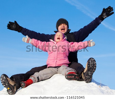 Family in winter park. Happiness father with daughter