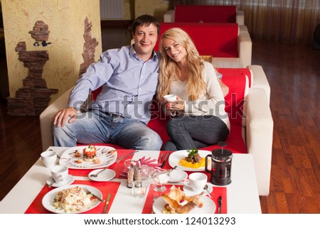 Young couple sitting in cafe. Man and woman in restaurant