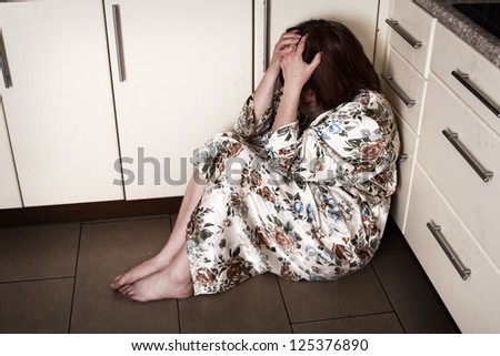 Adult woman crying sitting on the floor. Hopelessness, depressions, sadness, stress, grief, loneliness, problems.