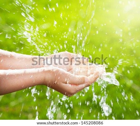 Stream Of Clean Water Pouring Into Children\'S Hands.