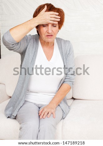 Adult woman has a headache. Sad mature female