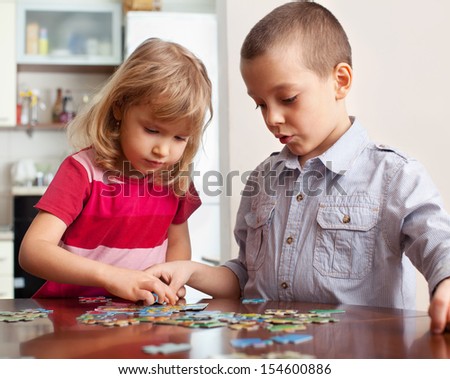 Children playing puzzles at home Children playing puzzles at home