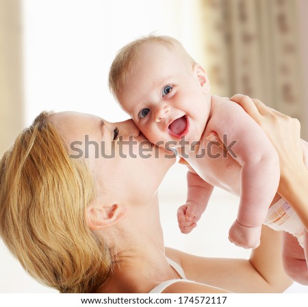 Mother with baby at home Happy family with newborn indoors Mother with baby at home Happy family with newborn indoors