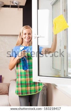 Woman washing window. Housewife cleaning window at home. Housework