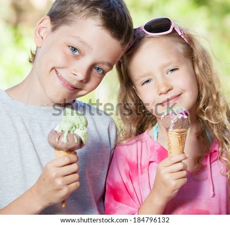 Happy children with ice cream outdoors
