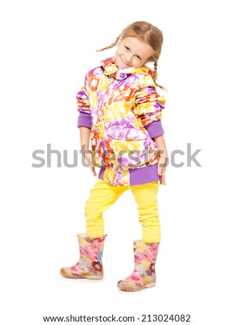 Girl in autumn clothes and rubber boots. Child in gumboots