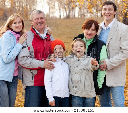 Families with children and grandparents in autumn park