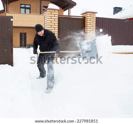 Man cleans snow shoveling around the house.
