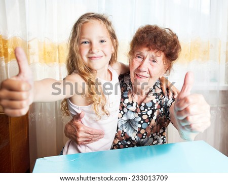 Senior with girl. Generation. Elderly woman with great-grandchild showing sign ok