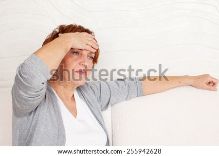 Adult woman has a headache. Sad mature female