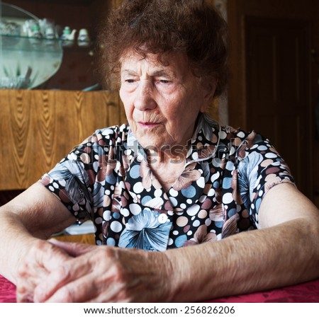 Old woman. Elderly sad female at home. Sorrow