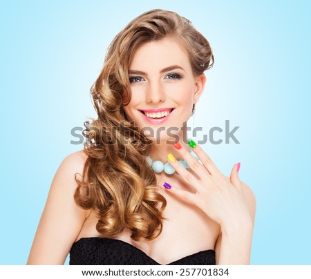 Young woman portrait with colorful makeup and nail polish, manicure, studio shot