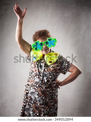 Merry old woman. Happy fun granny. Adult funny dancing female on party