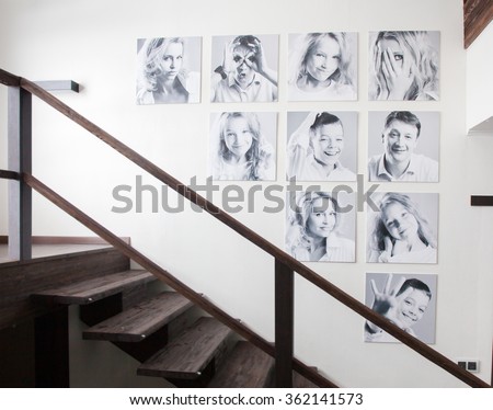 Family photos on the wall. Portraits of family stairwell