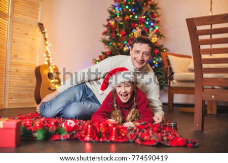 Child with dad near christmas tree at home. Merry christmas and happy New year