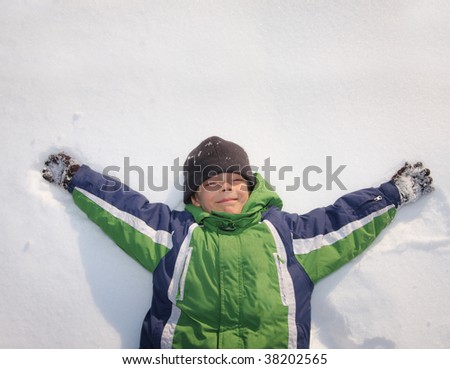Happiness boy laying on snow