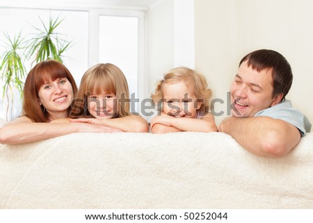 Happy family with two children on sofa
