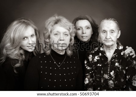 Four generations of women in a family on black