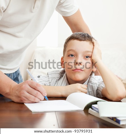 Father helping son do homework. Problems with homework