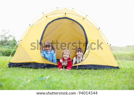 Happy children in tent. Family outdoors
