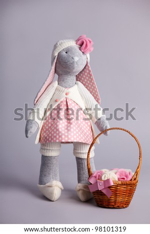 Soft toy rabbit on gray background. Handmade