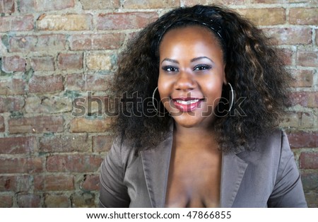 stock photo Black pregnant girl posing at the red brick wall
