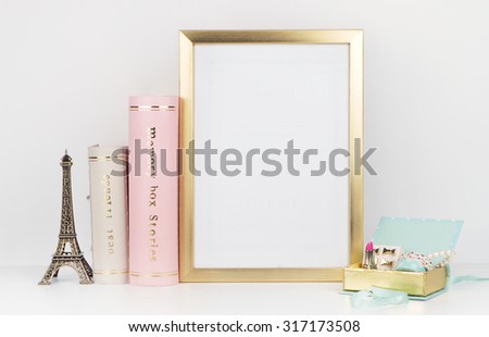 gold picture frame with decorations. Mock up for your photo or text Place your work, print art,shabby style, white background,, pastel color book, paris, lipstick, mint and gold accessories