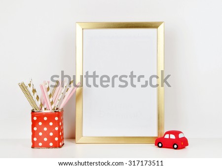 Gold frame mock up and toy red car, vase red and polka dots pattern. vintage
