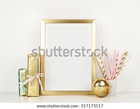 gold picture frame with decorations. Mock up for your photo or text Place your work, print art,shabby style, white background, paper ball, toy, pastel color book