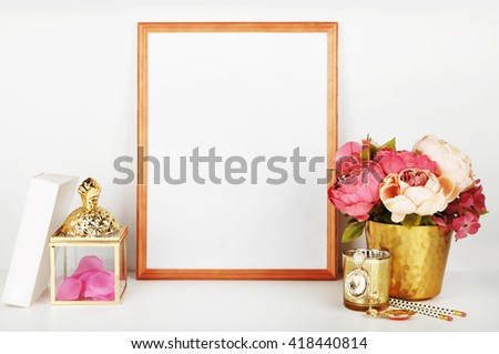 Wood frame with gold vase and gold items. Frame mock-up.