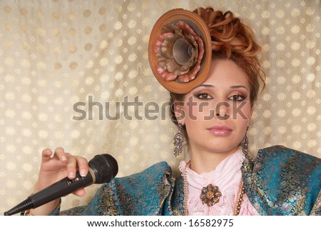 Glamour young girl portrait with microphone. Model name Hvoya
