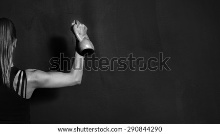 Fitness, Athletic Strong Woman Workout with Dumbbell showing biceps on black background