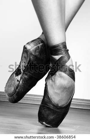 A pair of well worn black ballet shoes, studio shot Black and white