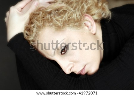Portrait of blond woman in deep thoughts,sorrow and depression ,soft focus studio shot