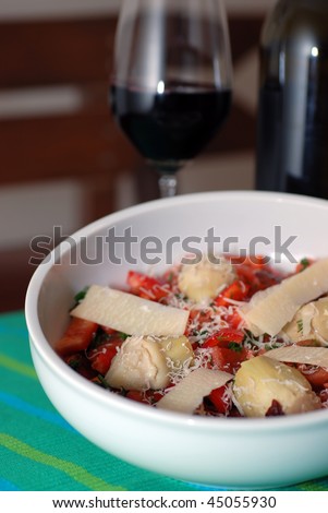 Artichoke heart salad with a glass of red wine (ingredients:red-bell pepper,parmesan cheese,sun-dried tomato,fresh tomato and dill with olive oil and lemon juice)