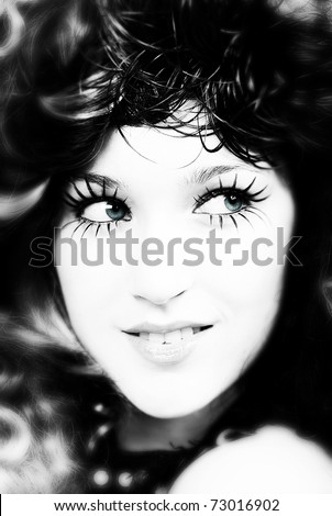 Blue eyed girl wearing fake eye lashes, black and white studio shot