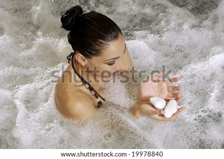 Woman holding stones in a Hydro massage