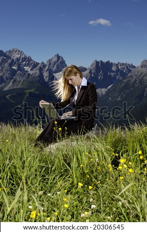 Woman and laptop in the mountain