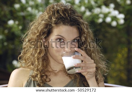 Woman drinking milk in the garden