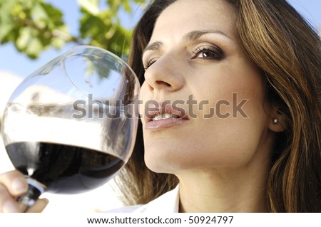 Adult woman smelling wine