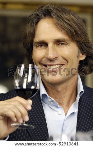 Smiling man with red wine
