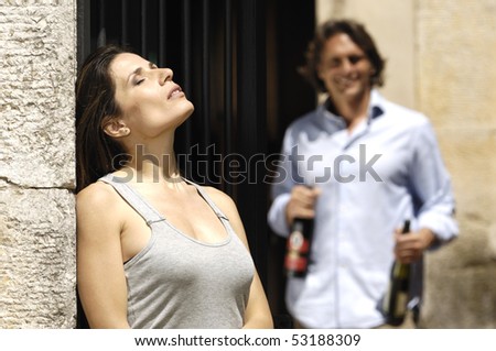 man with bottles and woman tanning