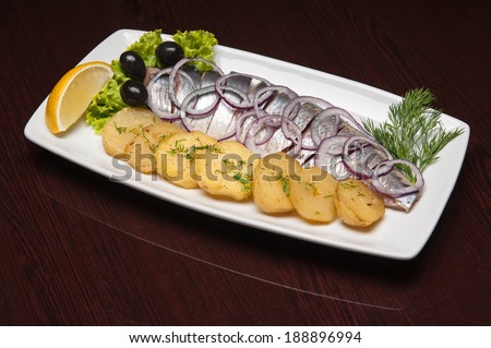 The menu - photo - appetizing herring with potatos and onion