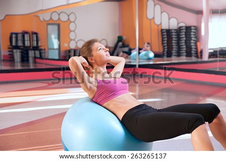 beautiful woman in a fitness club swings press