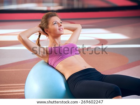beautiful woman in a fitness club swings press