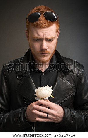bearded man with a white rose in his hand