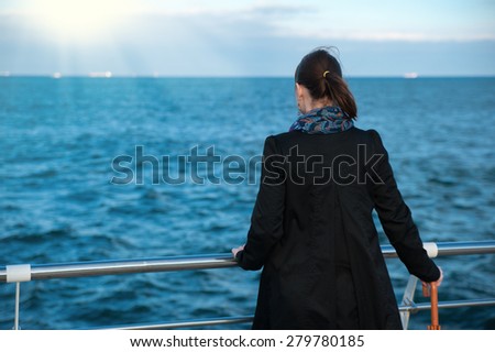 woman looks at the horizon of the sea
