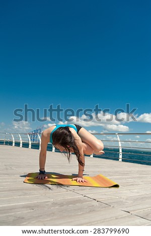Yoga. Handstand on the sea background